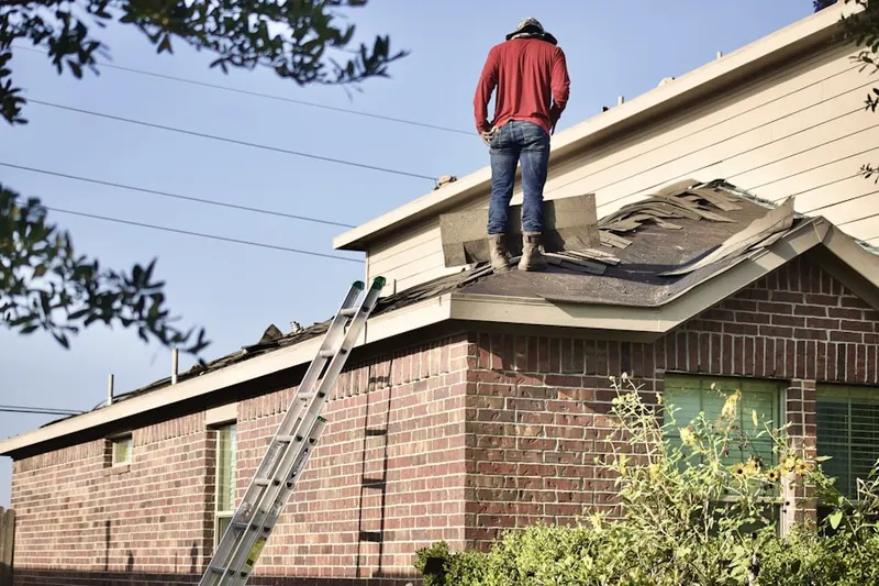 Professional roofer working on a residential roof in Downtown Dayton